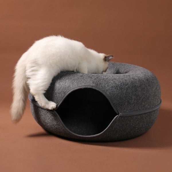 Image of a cat climbing over the side of the donut cat tunnel - New Forest Pets.